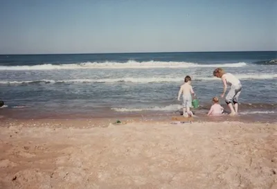 Mike Tarpey playing at Daytona Beach as a toddler, with his mom and sister.